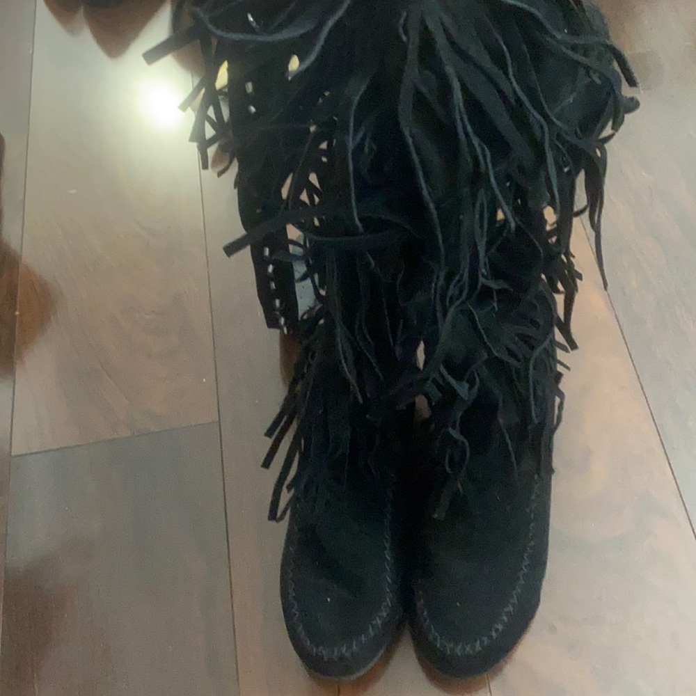 Black moccasin fringe knee wedge boot with belt on top